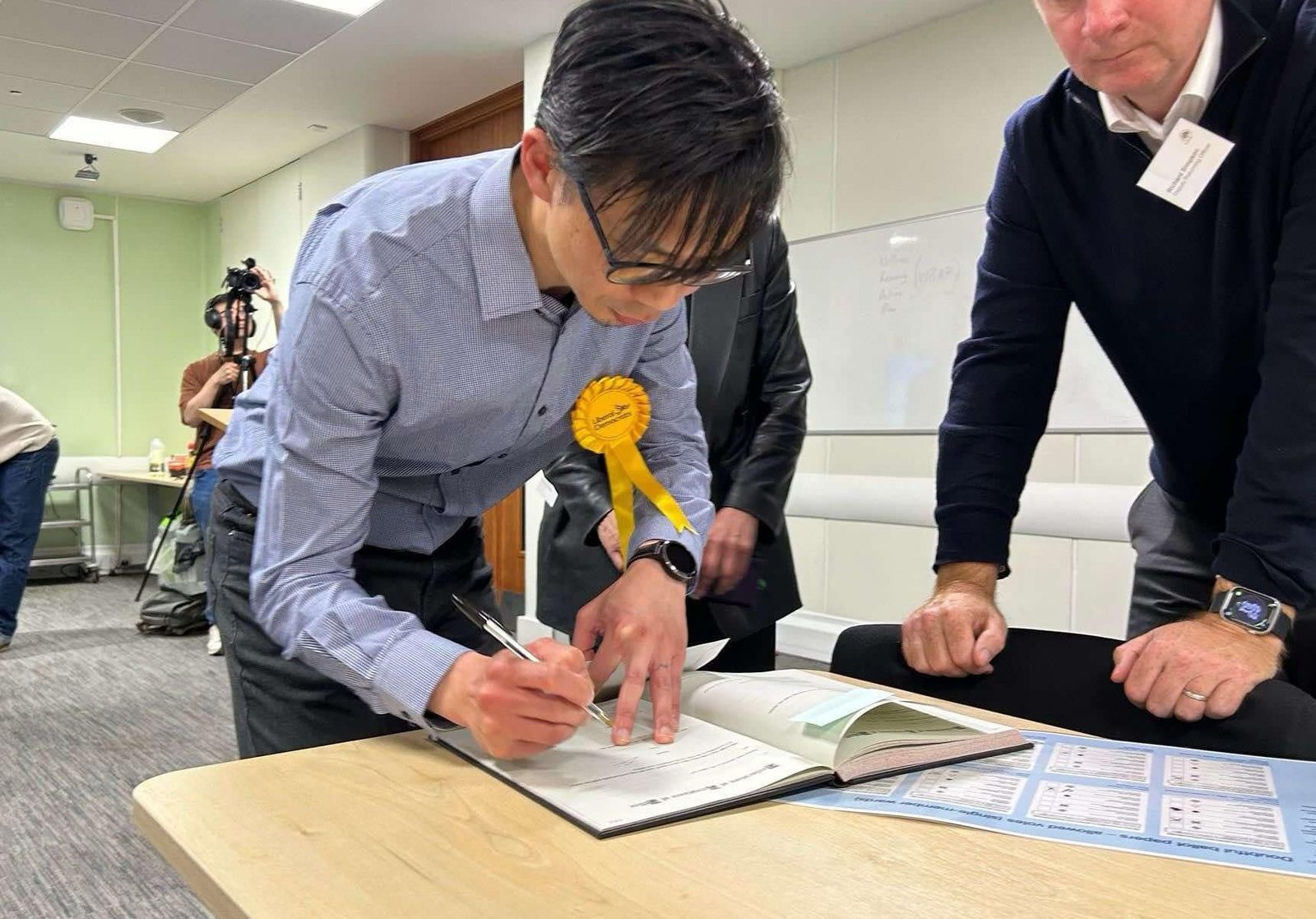 Richard Choi signing in as councillor after the by-election win