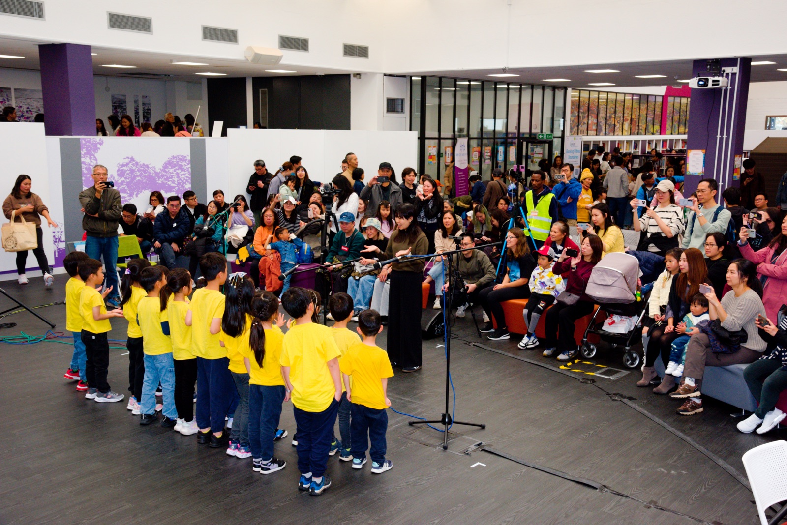 Children's choir performing to a packed hall at the 2025 Sutton Mid-Autumn celebration