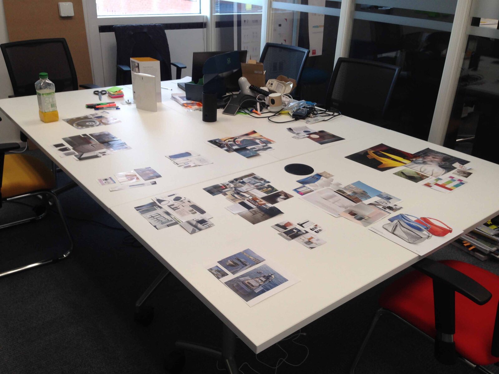 Design workshop — competitor and trend review spread across the studio table